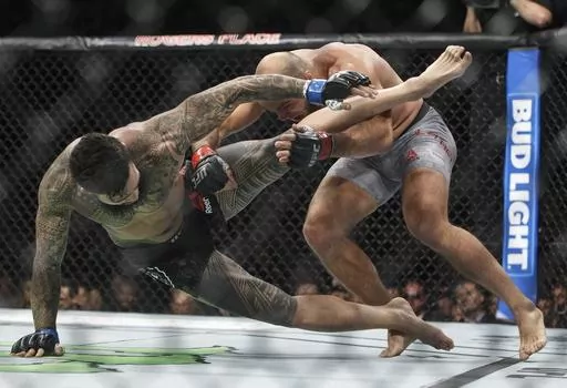 In this Sept. 9, 2017, file photo, ILir Latifi, right, of Sweden, takes down Tyson Pedro, of Australia, during their mixed martial arts bout at UFC 215 in Edmonton, Alberta. Bud Light is set to return as the official beer of UFC in the U.S. next year. Under a new multi-year marketing deal between UFC and Bud Light maker Anheuser-Busch, the brewer will become the mixed martial arts organization's “Official Beer Partner” in the U.S. starting Jan. 1, per a joint announcement on Tuesday, Oct. 24