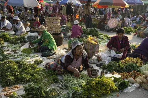 Vendors selling groceries wait for customers at a local market Saturday, Feb. 1, 2025, in Naypyitaw, Myanmar. (AP Photo/Aung Shine Oo)