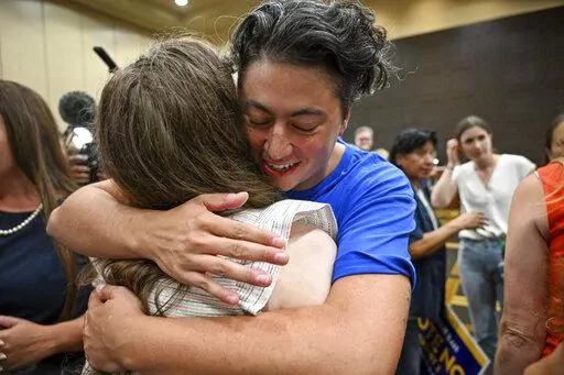 Iman Alsaden, chief medical officer for Planned Parenthood Great Plains, hugs Rachel Sweet, campaign manager for Kansans for Constitutional Freedom, Tuesday, Aug. 2, 2022, at the Overland Park Convention Center in Overland Park, Kan. Kansas voters protected the right to get an abortion in their state, rejecting a measure that would have allowed their Republican-controlled Legislature to tighten abortion restrictions or ban it outright. (Tammy Ljungblad/The Kansas City Star via AP)