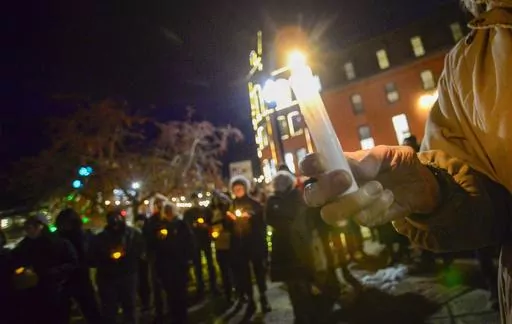 People gather in Pliny Park in Brattleboro, Vt., for a vigil, Monday, Nov. 27, 2023, for the three Palestinian-American students who were shot while walking near the University of Vermont campus in Burlington, Vt., Saturday, Nov. 25. The three students were being treated at the University of Vermont Medical Center, and one faces a long recovery because of a spinal injury, a family member said. (Kristopher Radder/The Brattleboro Reformer via AP)