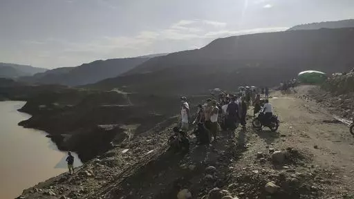 Miners, rescuers and local residents look at the jade mine site where a landslide accident took place in Hpakant township, Kachin state, Myanmar Sunday, Aug. 13, 2023. A landslide at the jade mine left scores of people missing, and a search and rescue operation was underway on Monday, a rescue official said. (AP Photo)