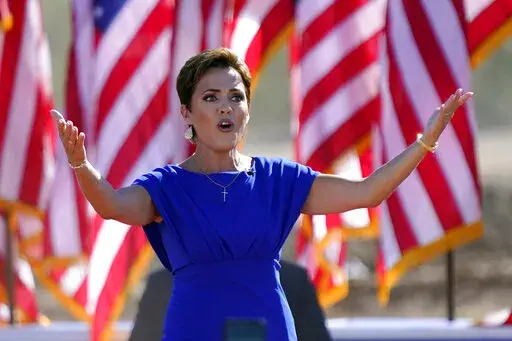 Arizona Republican gubernatorial candidate Kari Lake arrives to a rally with former President Donald Trump on Oct. 9, 2022, in Mesa, Ariz. The Republicans running for Arizona's three top statewide offices have said they would not have signed off on the presidential results if they had held office in 2020 and have signaled that they want to overhaul the battleground state's elections.(AP Photo/Matt York, File)