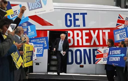 Britain's Prime Minister Boris Johnson addresses his supporters prior to boarding his General Election campaign trail bus in Manchester, England, Friday, Nov. 15, 2019. The moving vans have already started arriving in Downing Street, as Britain's Conservative Party prepares to evict Johnson. Debate about what mark he will leave on his party, his country and the world will linger long after he departs in September. (AP Photo/Frank Augstein, Pool, File)