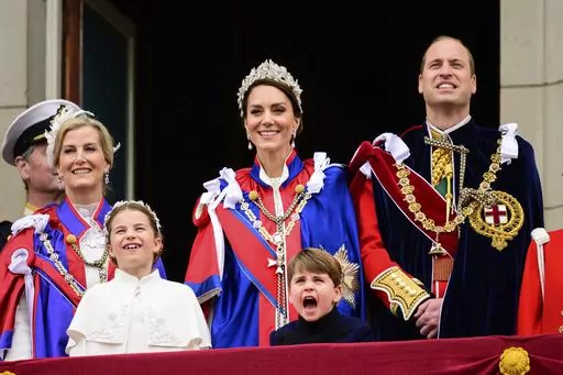Sophie, Duchess of Edinburgh, left, Kate, Princess of Wales, centre, Prince William, right, stand on the balcony of Buckingham Palace with Princess Charlotte, down left, and Prince Louis, down centre, during the coronation of Britain's King Charles III, in London, Saturday, May 6, 2023. (Leon Neal/Pool Photo via AP)