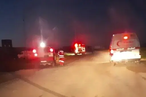 This frame grab from a video released by the Palestinian Red Crescent Society, taken with a phone by one of the 15 Palestinians medics killed, shows Red Crescent emergency vehicles, their lights and sirens flashing and their logos clearly visible, seconds before they came under a barrage of gunfire from Israeli army soldiers in Tel al-Sultan, a district of the southern Gaza Strip town of Rafah, early Sunday, March 23, 2025. (Palestinian Red Crescent Society via AP)