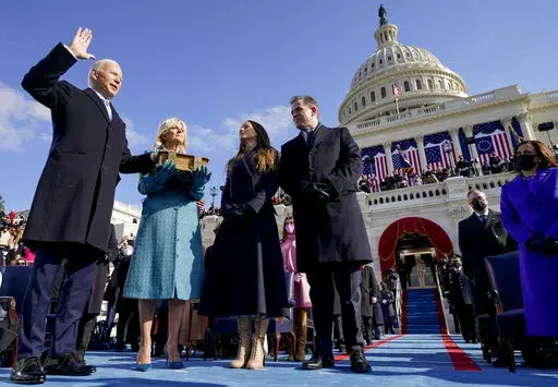 Joe Biden is sworn in as the 46th president of the United States by Chief Justice John Roberts as Jill Biden holds the Bible during the 59th Presidential Inauguration at the U.S. Capitol in Washington, on Jan. 20, 2021, as their children Ashley and Hunter watch.(AP Photo/Andrew Harnik, Pool, File)