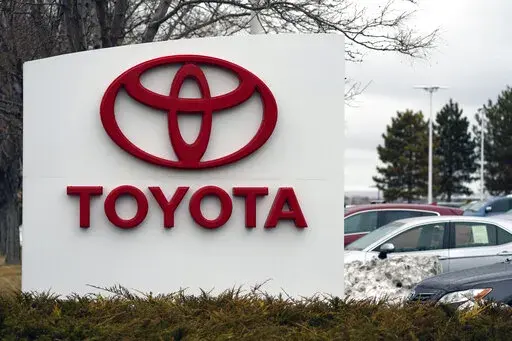 In this Sunday, March 21, 2021, photo, the company logo adorns a sign outside a Toyota dealership in Lakewood, Colo. Toyota customers soon won’t be able to get U.S. federal tax credits for buying electric or plug-in hybrid vehicles. Toyota's sales chief for North American, Bob Carter, said Wednesday, April 6, 2022, that the automaker expects to reach a 200,000-vehicle cap on the credits before the end of June. (AP Photo/David Zalubowski, File)