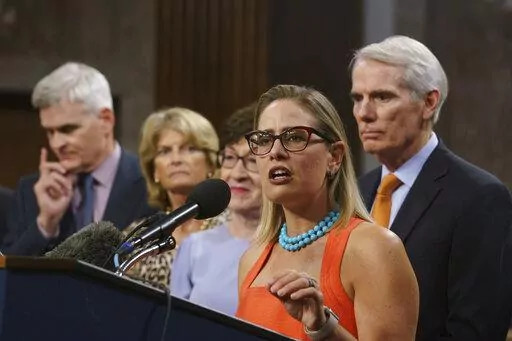 Sen. Kyrsten Sinema, D-Ariz., center, joined from left by, Sen. Bill Cassidy, R-La., Sen. Lisa Murkowski, R-Alaska, Sen. Susan Collins, R-Maine, and Sen. Rob Portman, R-Ohio, speak to reporters just after a vote to start work on a nearly $1 trillion bipartisan infrastructure package, at the Capitol in Washington, July 28, 2021. Sinema received a $1 million surge of campaign cash over the past year from private equity professionals, hedge funds and venture capitalists whose interests she has stau