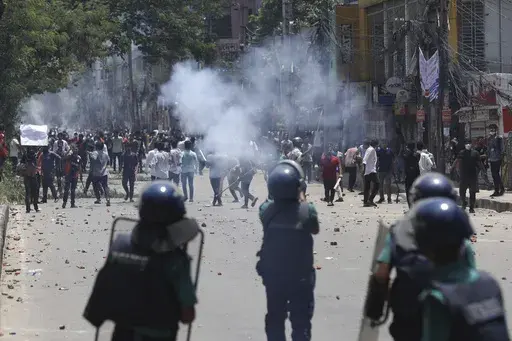 Students clash with riot police during a protest against a quota system for government jobs, in Dhaka, Bangladesh, Thursday, July 18, 2024. (AP Photo/Rajib Dhar)