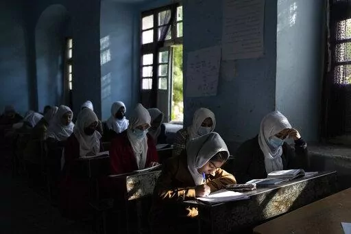 Afghan girls participate in a lesson at Tajrobawai Girls High School in Herat, Afghanistan on Nov. 25, 2021. In a surprise decision the hardline leadership of Afghanistan's new rulers has decided against opening educational institutions to girls beyond Grade six, a Taliban official said Wednesday, March 23, 2022 on the first day of Afghanistan's new school year. (AP Photo/Petros Giannakouris, File)