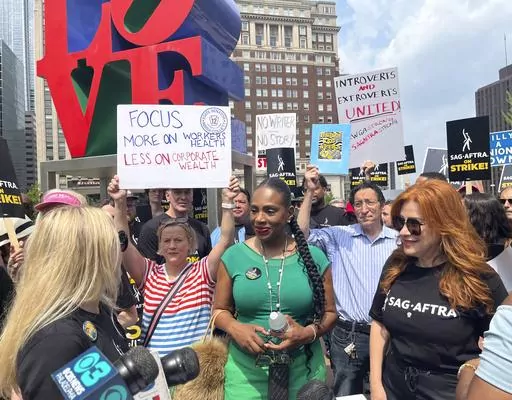 Actors Sheryl Lee Ralph, left, and Lisa Ann Walter, members of the cast of "Abbott Elementary," participate in a rally in support of the actors and writers strikes at Love Park in Philadelphia on Thursday, July 20, 2023. The actors strike comes more than two months after screenwriters began striking in their bid to get better pay and working conditions. (AP Photo/Tassanee Vejpongsa)