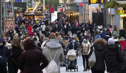 People wear mandatory face masks walk along a street in Dortmund, Germany, Dec. 1, 2021. Inflation in the 19 countries that use the euro currency hit a new high of 5.0% in December, breaking the record set the previous month. (AP Photo/Martin Meissner, File)