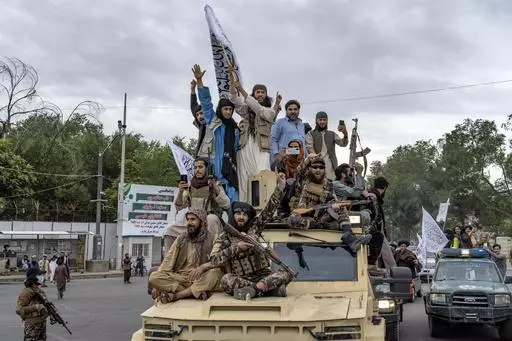 Taliban fighters celebrate one year since they seized the Afghan capital, Kabul, in front of the U.S. Embassy in Kabul, Afghanistan, Monday, Aug. 15, 2022. (AP Photo/Ebrahim Noroozi, File)