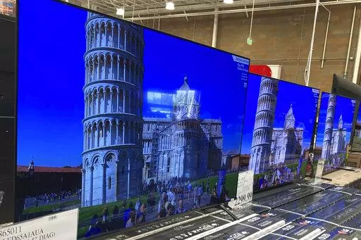 A 65-inch television is shown at a warehouse, Thursday, June 17, 2021, in Lone Tree, Colo. Buy now, pay later loans allow users to pay for items such as new sneakers, electronics or luxury goods in installments. (AP Photo/David Zalubowski, File)