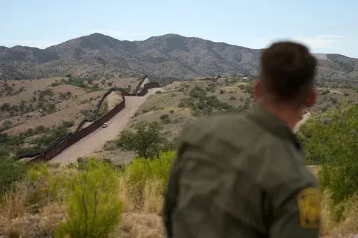Border patrol agent Pete Bidegain looks from a hilltop on the U.S. side of the US-Mexico border in Nogales, Ariz. on Tuesday, June 25, 2024. (AP Photo/Jae C. Hong, Pool, File)