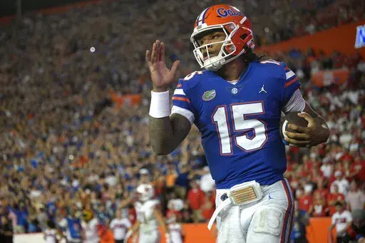 Florida quarterback Anthony Richardson (15) runs through the end zone after rushing for a 45-yard touchdown during the first half of an NCAA college football game against Utah, Saturday, Sept. 3, 2022, in Gainesville, Fla. (AP Photo/Phelan M. Ebenhack)