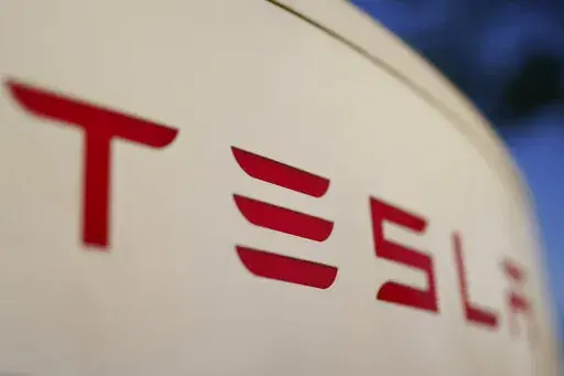 The logo for the Tesla Supercharger station is seen in Buford, Ga, April 22, 2021,. Tesla is recalling nearly 579,000 vehicles in the U.S. because sounds played over an external speaker can obscure audible warnings for pedestrians. The recall is the fourth made public in the last two weeks as U.S. safety regulators increase scrutiny of the nation’s largest electric vehicle maker. (AP Photo/Chris Carlson, File)