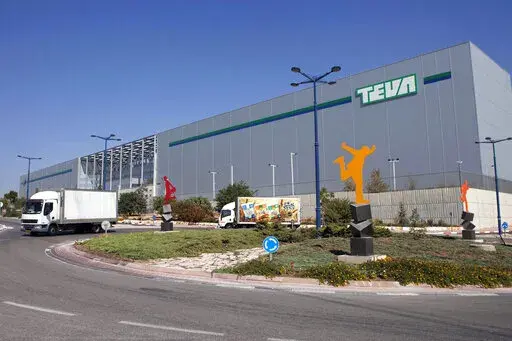 FILE - Trucks drive in front of Teva Pharmaceutical Logistic Center in the town of Shoam, Israel, Oct. 16, 2013. A jury held Teva Pharmaceuticals responsible, Thursday, Dec. 30, 2021, for contributing to the opioid crisis, delivering a verdict in a sweeping lawsuit filed by New York state, the state attorney general said. (AP Photo/Dan Balilty, File)