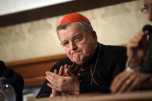 Cardinal Raymond Burke applauds during a news conference at the Italian Senate, in Rome, on Sept. 6, 2018. Pope Francis has taken measures to punish one of his highest-ranking critics, Cardinal Raymond Burke, by yanking his right to a Vatican apartment and salary in the second such radical action against a conservative American prelate this month, according to two people briefed on the measures. (AP Photo/Alessandra Tarantino, File)