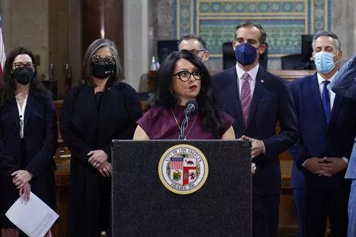 Los Angeles City Council President Nury Martinez at podium, and Mayor Eric Garcetti, standing to her right, are seen during a news conference at Los Angeles City Hall in Los Angeles on April 1, 2022. The president of the Los Angeles City Council resigned from the post Monday, Oct. 10, 2022, after she was heard making racist comments and other coarse remarks in a leaked recording of a conversation with other Latino leaders. Council President Nury Martinez issued an apology and expressed shame. (A