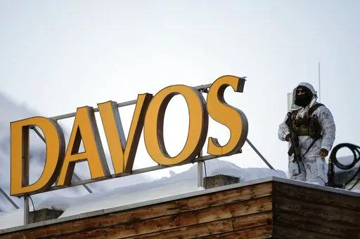 File---File picture taken Jan.24, 2022 shows a police security guard on the roof of a hotel ahead of the World Economic Forum in Davos, Switzerland. (AP Photo/Markus Schreiber,file)