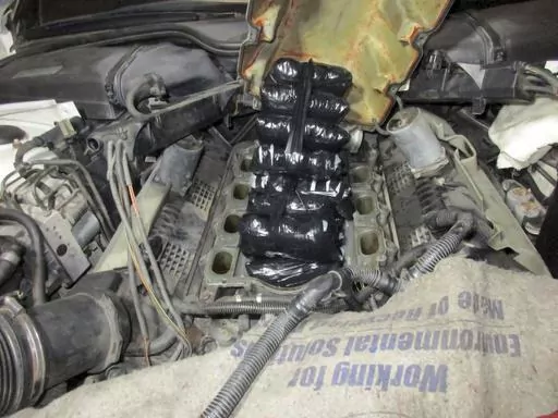This Sept. 12, 2021 photo provided by the U.S. Customs and Border Protection shows drugs concealed inside the engine of a car. A former Marine who for years helped smuggle drugs from Mexico into the United States has been sentenced to 12 years in federal prison. Twenty-six-year-old Roberto Salazar II of San Diego was sentenced Friday, April 21, 2023, for importing fentanyl and for conspiracy to distribute heroin, methamphetamine, cocaine and fentanyl. (U.S. Customs and Border Protection via AP)