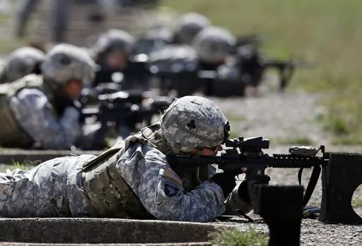 Female soldiers from 1st Brigade Combat Team, 101st Airborne Division train on a firing range while testing new body armor in Fort Campbell, Ky., Sept. 18, 2012. Female soldiers face rampant sexism, harassment and other gender-related challenges in male dominated Army special operations units, according to a report Monday, Aug. 21, 2023, eight years after the Pentagon opened all combat jobs to women. (AP Photo/Mark Humphrey, File)
