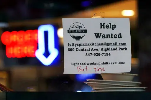 Hiring sign is displayed at a restaurant in Highland Park, Ill., Thursday, July 14, 2022.   The number of Americans applying for unemployment benefits last week rose to its highest level in more than eight months, a sign the labor market may be showing some weakness. Applications for jobless aid for the week ending July 16 rose by 7,000 to 251,000, up from the previous week’s 244,000, the Labor Department reported Thursday, July 21.  (AP Photo/Nam Y. Huh)