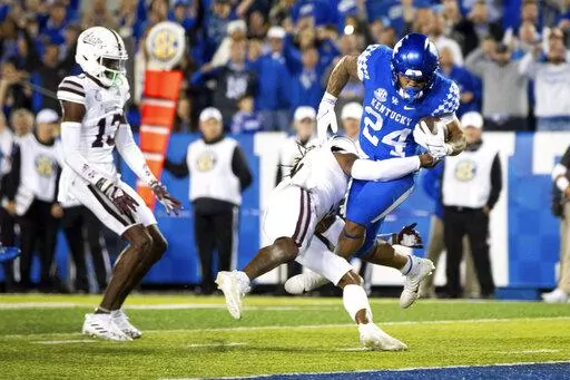 Kentucky running back Chris Rodriguez Jr. (24) is tackled into the end zone for a touchdown by Mississippi State defensive end Jordan Davis during the second half of an NCAA college football game in Lexington, Ky., Saturday, Oct. 15, 2022. (AP Photo/Michael Clubb)
