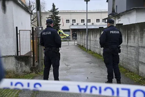 Police secure access to the elementary school where a 7-year-old girl died and a teacher and five other students were wounded in a knife attack in Zagreb, Croatia, Friday, Dec. 20, 2024. (AP Photo/Ronald Gorsic)