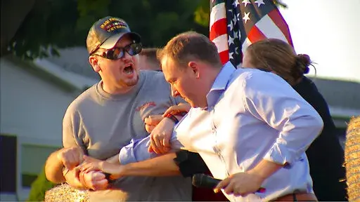 In this image taken from video provided by WHEC-TV, David Jakubonis, left, is subdued as he brandishes a sharp object during an attack U.S. Rep. Lee Zeldin, right, as the Republican candidate for New York governor delivered a speech in Perinton, N.Y., Thursday, July 21, 2022. Jakubonis, 43, has been charged with attempted assault, arraigned and released, a Monroe County sheriff's spokesperson said. (WHEC-TV via AP)