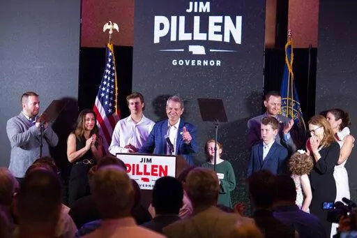 University of Nebraska Regent Jim Pillen, center, gives a thumbs up to a wave of applause as he is named the winner of the Nebraska Republican gubernatorial primary during an election night party at the Embassy Suites on Tuesday, May 10, 2022, in Lincoln, Neb.  (Kenneth Ferriera/Lincoln Journal Star via AP)