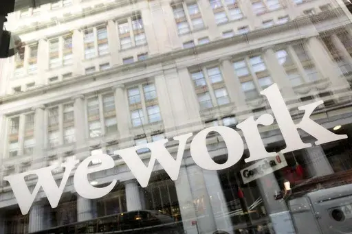 The WeWork logo is seen at one of the company's offices, Jan. 16, 2020, in New York. WeWork has officially emerged from bankruptcy — and appointed a new leadership in the process. (AP Photo/Mark Lennihan, File)