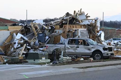 A damaged car sits by homes destroyed from severe weather in the West Creek Farms neighborhood on Sunday, Dec. 10, 2023, Clarksville, Tenn. If your home was hit by high water or a fire emergency, would your important papers be safe? Items like insurance information, birth and marriage certificates, passports, Social Security cards and estate planning paperwork should all be protected in case the worst happens. (AP Photo/Mark Zaleski, File)