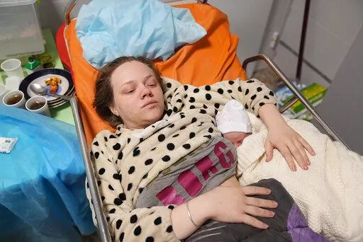 Mariana Vishegirskaya lies in a hospital bed after giving birth to her daughter Veronika, in Mariupol, Ukraine, Friday, March 11, 2022. Vishegirskaya survived the Russian airstrike on a children’s and maternity hospital in Mariupol last Wednesday. (AP Photo/Evgeniy Maloletka)