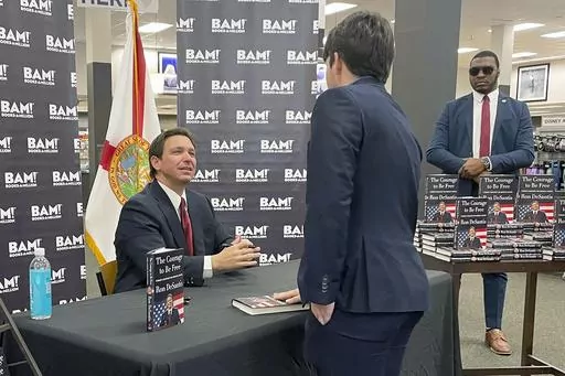 Florida Gov. Ron DeSantis greets supporters at a book signing event, Thursday, March 23, 2023 in Tallahassee, Fla. Allies of DeSantis are gaining confidence in his White House prospects as former President Donald Trump’s legal woes mount. Trump is facing possible criminal charges in New York, Georgia and Washington as he runs for president again. (AP Photo/Steve Peoples)