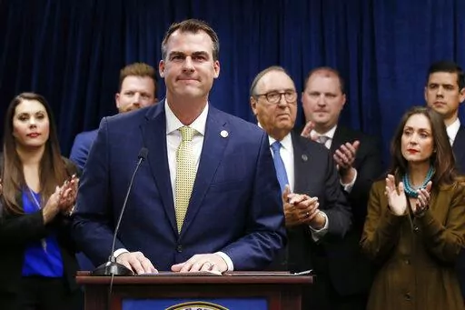 Oklahoma Gov. Kevin Stitt is applauded after speaking at a news conference, Nov. 1, 2019, in Oklahoma City, to announce that Oklahoma will release more than 400 inmates after the board approved what they say is the largest single-day mass commutation in U.S. history. Stitt, a Republican running for a second term, is facing criticism for a 2019 mass commutation he said saved the state millions of dollars in prison costs. (AP Photo/Sue Ogrocki, File)