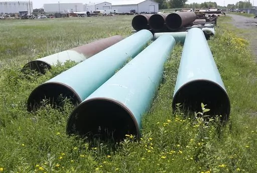 Pipeline used to carry crude oil sits at the Superior, Wis., terminal of Enbridge Energy, June 29, 2018. Attorneys for a Wisconsin Native American tribe are set to argue Thursday, May 18, 2023, that a federal judge should order an energy company to shut down an oil pipeline the tribe says is at immediate risk of being exposed by erosion and rupturing on reservation land. (AP Photo/Jim Mone, File)