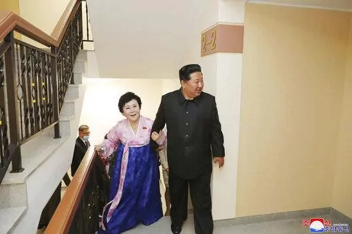 In this photo provided by the North Korean government, Kim Jong Un visits the new house of Korean Central Broadcasting announcer Ri Chun Hi, second right, after attending an inauguration ceremony of Pothong riverside terraced residential district in Pyongyang, North Korea Wednesday, April 13, 2022. Independent journalists were not given access to cover the event depicted in this image distributed by the North Korean government. The content of this image is as provided and cannot be independently
