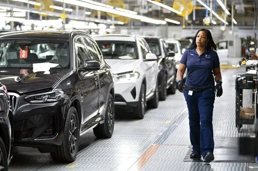 An employee works in the X3, X45 assembly hall at the BMW Spartanburg plant in Greer, S.C., Oct. 19, 2022. With inflation a top concern for voters, many Republican candidates are seeking to capitalize on Americans’ precarious financial situations heading into next week’s midterm elections to vilify a key component of President Joe Biden’s climate agenda: electric vehicles.  (AP Photo/Sean Rayford, File)