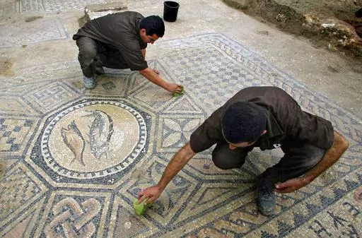 Prisoners work at a nearly 1,800-year-old decorated floor from an early Christian prayer hall discovered by Israeli archaeologists on Sunday, November 6, 2005 in the Megiddo prison. Israeli officials are considering uprooting the mosaic and loaning it to the controversial Museum of the Bible in Washington D.C., a proposal that has upset archaeologists and underscores the hardline government's close ties with evangelical Christians in the U.S. (AP Photo/Ariel Schalit, File)