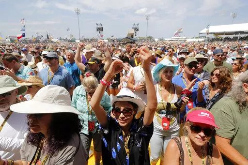 Fans cheer at the New Orleans Jazz & Heritage Festival in New Orleans, Thursday, May 2, 2019. After a two-year hiatus brought on by the coronavirus pandemic, the New Orleans Jazz & Heritage Festival returns this spring with headliners The Who, Stevie Nicks, Foo Fighters, Lionel Richie, Erykah Badu, Ludacris, Nelly and Willie Nelson. Festival organizers announced the lineup for the festival Thursday, Jan. 20, 2022. (AP Photo/Gerald Herbert)