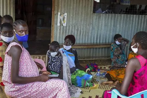 Expectant mothers sit on the floor as they wait to attend a monthly checkup at the Mingkaman Reproductive Health Clinic in the village of Mingkaman, Awerial County, in the Lakes State of South Sudan Wednesday, Oct. 19, 2022. In a country with one of the world's highest maternal mortality rates, the small clinic dedicated to reproductive health care for more than 200,000 people is about to be shut down - just one casualty among many in developing countries as humanitarian donors are stretched by 