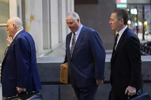 Former Ohio House Speaker Larry Householder, center, walks into Potter Stewart U.S. Courthouse with his attorneys, Mark Marein, left, and Steven Bradley, right, before jury selection in his federal trial, Jan. 20, 2023, in Cincinnati, Ohio. Householder and former Ohio Republican Party Chair Matt Borges were convicted Thursday, March 9, 2023, in a $60 million bribery scheme that federal prosecutors have called the largest corruption case in state history. (AP Photo/Joshua A. Bickel, File)