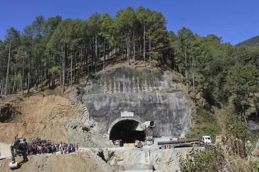 FILE- People watch rescue and relief operations at the site of an under-construction road tunnel that collapsed in mountainous Uttarakhand state, India, Wednesday, Nov. 15, 2023. All 41 construction workers who were trapped have been pulled out after 17 days, on Tuesday, Nov. 28. The efforts to reach the workers, aided by international tunneling experts and spearheaded by multiple Indian rescue agencies, was one of the most significant and complicated rescue operations in India’s recent histor