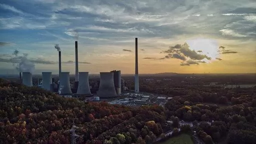 The sun sets behind a coal-fired power plant in Gelsenkirchen, Germany, Oct. 22, 2022. A new report from doctors and other health experts says the world's fossil fuel addiction is making the world sicker and is killing people. (AP Photo/Michael Sohn, File)