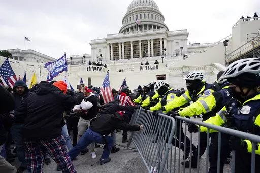 Violent insurrections loyal to President Donald Trump break through a police barrier at the Capitol in Washington. Over months, the House Select Committee investigating the Jan. 6 U.S. Capitol insurrection has issued more than 100 subpoenas, done more than 1,000 interviews and probed more than 100,000 documents to get to the bottom of the attack that day in 2021 by supporters of former President Donald Trump. (AP Photo/Julio Cortez, File)