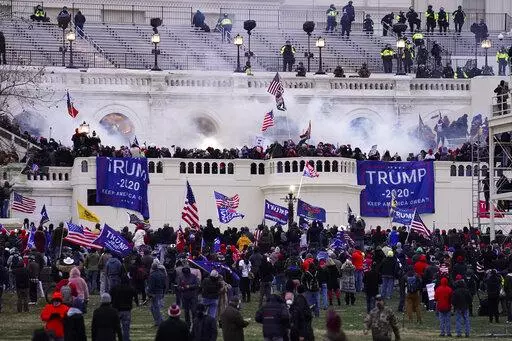 Violent protesters, loyal to President Donald Trump, storm the Capitol on Jan. 6, 2021, in Washington. The platform Gab launched in 2016 and now claims to have 15 million monthly visitors, though that number could not be independently verified. The service says it saw a huge jump in signups following the January 6 riot, which prompted Facebook, Twitter and YouTube to crack down on Trump and others who they said had incited violence. (AP Photo/John Minchillo, File)