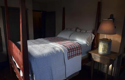This Nov. 11, 2013 file photo shows a bedroom built by Mike Spangler using some reclaimed materials, in Belle, W.Va. Nearly one-third of American adults don't get the recommended seven to nine hours of sleep per night. Some of the major causes: Stress, anxiety and a culture that experts say is about productivity, not rest. (Craig Cunningham/Charleston Daily Mail via AP, file)