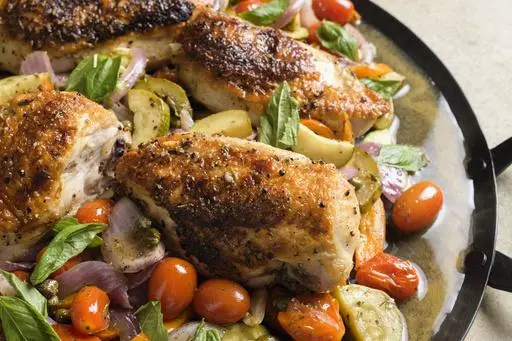 This image released by Milk Street shows a recipe for pan-roasted chicken and summer vegetables. (Milk Street via AP)